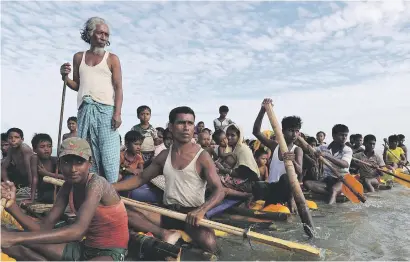  ?? Picture: Reuters ?? SEEKING REFUGE. Rohingya refugees cross the Naf River with an improvised raft to reach Bangladesh.