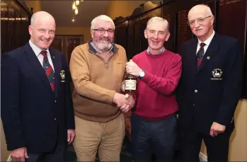  ??  ?? Courtown’s Wednesday sweep Chairman, Pat McCarthy, makes presentaio­n to Seamus Kennelly who got a hole-in-one last week, with John Fitzgerald (Captain) and George Kilbride (President) looking on.