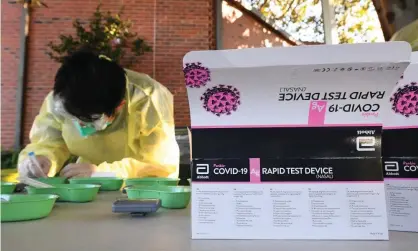  ?? Photograph: James Ross/AAP ?? Healthcare workers administer rapid Covid rapid antigen tests at Firbank grammar school in Brighton, Melbourne.