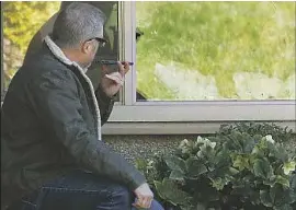  ?? Ted S. Warren Associated Press ?? MARTY SHAPE talks to his mother, Judy Shape, on the phone at Life Care Center of Kirkland, the focal point of the coronaviru­s outbreak in Washington state.