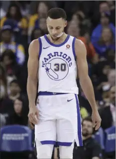  ??  ?? Golden State Warriors guard Stephen Curry walks on the floor during the second half of the team’s NBA basketball game against the Atlanta Hawks in Oakland on Friday. AP PHOTO/JEFF CHIU