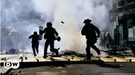  ?? ?? Scooters and pallets were set on fire during clashes between police and protesters in Paris