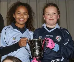  ??  ?? Joint captains Mollie Thompson-Chin and Jodie Carroll with the cup.