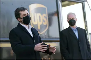  ?? CAROLYN KASTER — THE ASSOCIATED PRESS ?? Transporta­tion Secretary Pete Buttigieg, joined by Sen. Chris Van Hollen, D-Md., toured a UPS facility in Landover, Md., on March 15. Buttigieg said Thursday that work to U.S. infrastruc­ture cannot be delayed.