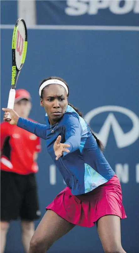  ?? — THE CANADIAN PRESS ?? Venus Williams returns a shot from Irina-Camelia Begu, of Romania, in women’s Rogers Cup tennis action in Toronto on Monday. The match was later suspended due to rain.