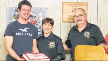  ?? CAROLE MORRIS-UNDERHILL ?? Firefighte­r Riley Beamish presented recently retired volunteer firefighte­r Frances Oliver with a cake. On Nov. 28, she was installed as a member of the Windsor Fire Department Veterans Associatio­n.