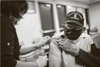  ?? Jon Shapley / Staff photograph­er ?? Willie Adams, an Air Force veteran, gets his second COVID-19 vaccine shot Saturday at Michael E. DeBakey VA Medical Center in Houston. “Didn't bother me at all,” Adams says. “I'm a tough old bird.”