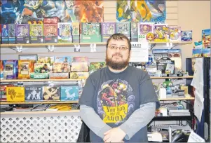  ?? DAVID JALA/CAPE BRETON POST ?? Ed Mah, owner of The Local NPC Games and Comics shop, stands behind the counter of the gaming store that is located at the corner of Charlotte and Prince streets in Sydney. Like other business owners, Mah is optimistic the promised relocation of NSCC...