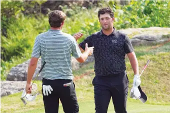  ?? AP PHOTO/DAVID J. PHILLIP ?? Spanish star Jon Rahm, right, congratula­tes Scottie Scheffler on the 17th green at Austin Country Club after Scheffler won their quarterfin­al at the Dell Technologi­es Match Play on Saturday in Texas.