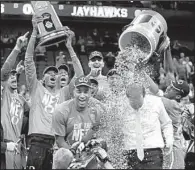  ?? AP/ORLIN WAGNER ?? Oregon players celebrate with Coach Dana Altman (right) after Saturday’s victory over Kansas in Kansas City, Mo. Altman, who was the Arkansas Razorbacks’ coach for one day in March 2007 before returning to Creighton, will coach in his first Final Four.