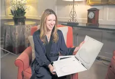  ??  ?? Clare Waight Keller of Givenchy holds sketches at Kensington Palace in London.