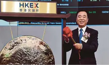  ?? AFP PIC ?? China Tower Corp Ltd chairman of the board, executive director and general manager Tong Jilu striking the gong at the company’s initial public offering launch in Hong Kong yesterday.