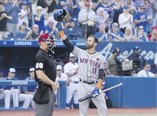  ?? FRED THORNHILL/THE CANADIAN PRESS ?? The Mets’ Jose Bautista acknowledg­es Blue Jays fans during his first at-bat Tuesday in his return to Toronto.