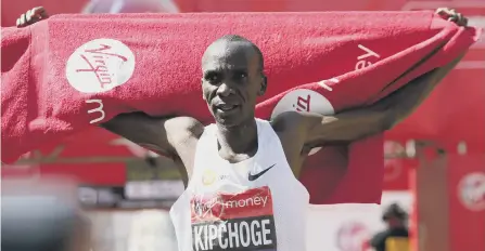  ??  ?? Kenya’s Eliud Kipchoge celebrates winning the men’s race in the 2018 Virgin Money London Marathon yesterday.