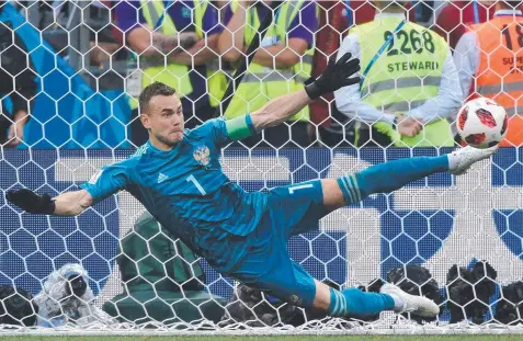  ?? Picture: AFP ?? MIRACULOUS: Russia's goalkeeper Igor Akinfeev throws a boot out to save Spain’s final penalty attempt from Iago Aspas.