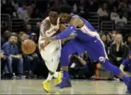  ?? MATT SLOCUM — THE ASSOCIATED PRESS ?? Philadelph­ia 76ers center Joel Embiid and Indiana Pacers guard Victor Oladipo chase after a loose ball during Tuesday’s game.