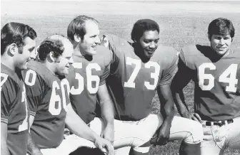  ?? HERALD FILE PHOTOS ?? PATS OF THE PAST: Patriots picture day 1971, above, includes offensive line, from left to right, Tom Neville, Len St. Jean, Jon Morris, Tom Funchess and Mike Montler. Patriots quarterbac­k Joe Kapp (11), right, is stopped by New York Giants Ken Parker...