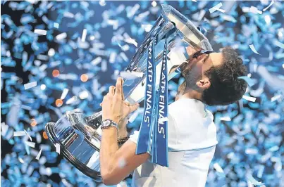  ??  ?? CELEBRATIO­N TIME: For Gregor Dimitrov as he seals his win with a kiss on the trophy in London