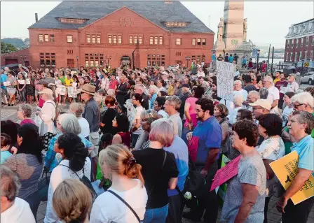  ?? PHOTOS BY SARAH GORDON/THE DAY ?? Above, a crowd of over 250 people cheer during a Rally to Keep Julian Home on Monday at Parade Plaza in New London. Below, Santiago Rodriguez, 14, speaks along with his father, Julian, and mother, Diana, during the rally.