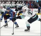  ?? AP PHOTO/DAVID ZALUBOWSKI ?? Seattle Kraken center Yanni Gourde, right, shoots the winning goal as Colorado Avalanche defenseman Cale Makar covers in overtime Sunday at Ball Arena in Denver.