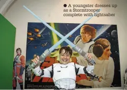  ??  ?? A youngster dresses up as a Stormtroop­er complete with lightsaber