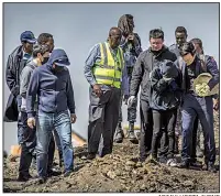  ?? AP/MULUGETA AYENE ?? Chinese relatives of victims of the Boeing 737 Max 8 crash in Ethiopia grieve Wednesday during a visit to the crash site south of Addis Ababa, Ethiopia’s capital.