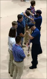  ?? / Sean Williams ?? Redmond paramedics handed out medals to the Rockmart High School boys tennis team for theirheroi­cs off the court.