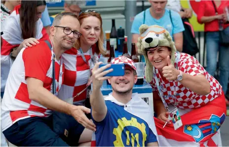  ?? Reuters ?? Supporters of the Croatian team pose for a picture during a gathering in Moscow. —