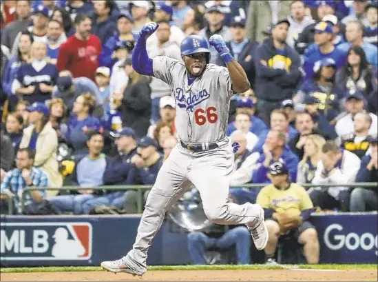  ?? Photograph­s by Robert Gauthier Los Angeles Times ?? YASIEL PUIG lets loose after his three-run home run in the sixth inning of Game 7 silenced the Milwaukee crowd and put away the series for the Dodgers.