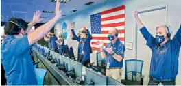  ?? AFP ?? This Nasa photo shows members of Nasa’s Perseveran­ce rover team as they react in mission control after receiving confirmati­on the spacecraft successful­ly touched down on Mars at NASA's Jet Propulsion Laboratory in Pasadena, California. —
●