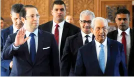  ??  ?? Tunisian Prime Minister Youssef Chahed arrives in Parliament on Monday with Speaker Mohamed Ennaceur before of a vote of confidence in his reshuffled government in Tunis. (AP)