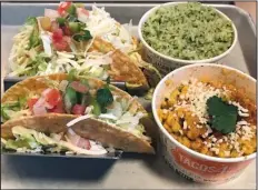  ?? Arkansas Democrat-Gazette/JENNIFER CHRISTMAN ?? Two Basic Beef tacos come with cilantro lime rice at Tacos 4 Life, but don’t miss the Mexican cream-style corn.