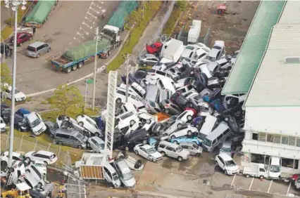  ??  ?? ... Vehicles mashed together in a heap after Typhoon Jebi tore through Kobe in the west coast of Japan yesterday.