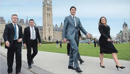  ?? JUSTIN TANG THE CANADIAN PRESS ?? Prime Minister Justin Trudeau and Minister of Foreign Affairs Chrystia Freeland walk to a press conference on the USMCA trade deal on Parliament Hill in Ottawa on Monday.
