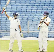  ?? PTI ?? Gautam Gambhir (left) after reaching his century during Delhi’s Ranji Trophy semifinal against Bengal, in Pune on Monday.