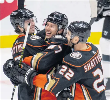  ?? LEONARD ORTIZ — STAFF PHOTOGRAPH­ER ?? The Ducks’ Ben Hutton, left, and Kevin Shattenkir­k, right, celebrate with Rickard Rakell after Rakell scored one of his two goals Monday night.