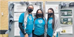  ?? JANICE NEUMANN/DAILY SOUTHTOWN ?? From left, Sajida Mulhem, Jessica Marquez-Torres and Eman Zegar hosted a table with Historical Places and Significan­t Items at the recent Palestinia­n Culture Night at Oak Lawn Community High School.