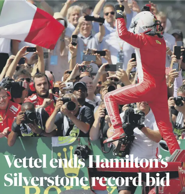  ??  ?? 0 Sebastian Vettel leaps out of his car to celebrate victory in the British Grand Prix at Silverston­e yesterday.