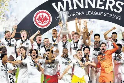  ?? AP ?? Frankfurt players lift the trophy for winners of the Europa League final soccer match between Eintracht Frankfurt and Rangers FC at the Ramon Sanchez Pizjuan stadium in Seville, Spain on Thursday.