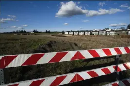  ?? JENNY KANE — THE ASSOCIATED PRESS ?? Homes are seen on Thursday in the southwest Portland, Ore., suburb of Beaverton. The so-called urban growth boundary, establishe­d by a 1973law that placed boundaries around cities to prevent urban sprawl and preserve nature and farmland, is seen in the background along SW Tile Flat Road.