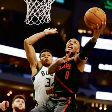  ?? FILE/JEFFREY PHELPS/ASSOCIATED PRESS ?? Damian Lillard (right) and Giannis Antetokoun­mpo (left) should make for an offensive dynamic duo as teammates but the Bucks could be missing something on defense.