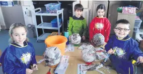  ?? ?? Busy getting their paper mâché planets ready for painting.