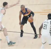  ?? REUTERS ?? PHOENIX Suns guard Chris Paul (3) controls the ball against Milwaukee Bucks center Brook Lopez (11) during the second half in game one of the 2021 NBA Finals at Phoenix Suns Arena.