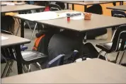  ?? ?? Students huddle under their desks as a part of the District’s earthquake drill Thursday morning.