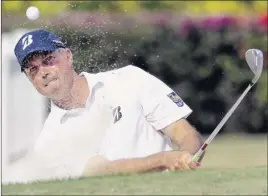  ?? Matt York / Associated Press ?? Matt Kuchar hits from the bunker on the ninth green Sunday at the Sony Open. Kuchar closed with a 66 for his second win this season.