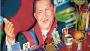  ?? ASSOCIATED PRESS FILE PHOTO ?? An image of the late Venezuelan President Hugo Chávez decorated with religious images is seen in July 2014 inside a small chapel in Caracas, Venezuela.