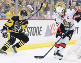  ?? AP PHOTO ?? Ottawa Senators’ Erik Karlsson kicks at the puck after getting it away from Pittsburgh Penguins’ Sidney Crosby during the second period of Game 1 of the Eastern Conference final in the NHL Stanley Cup playoffs in Pittsburgh.