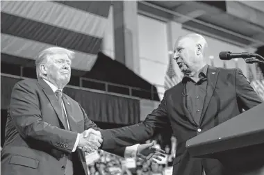  ?? Photos by Mary Altaffer/Associated Press ?? Ex-President Donald Trump greets Doug Mastriano, the Republican candidate for Pennsylvan­ia governor, during a rally Saturday. The appearance was Trump’s first since an FBI raid on his Mar-a-Lago residence.