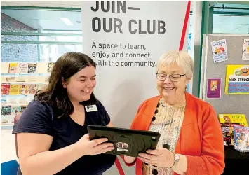  ?? ?? Library officer hannah Notman (left) and patron Carmel trying out the online service.