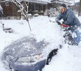  ?? AP ?? A man digs out his girlfriend’s car from a pile of snow in St. Louis, Missouri on Saturday.